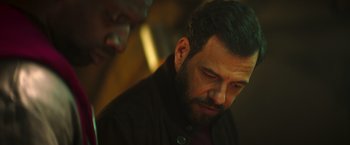 Movie still from “The Takedown” (2022), directed by Louis Leterrier – A person with a beard; Close Up shot, Low angle