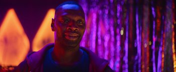 Movie still from “The Takedown” (2022), directed by Louis Leterrier – A person wearing a blue shirt; Close Up shot, Over the shoulder angle