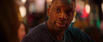 Movie still from “The Takedown” (2022), directed by Louis Leterrier – A man's face in a dark room; Close Up shot, Over the shoulder angle