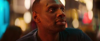 Movie still from “The Takedown” (2022), directed by Louis Leterrier – A man's face looking upward; Close Up shot, Low angle