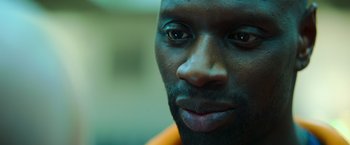 Movie still from “The Takedown” (2022), directed by Louis Leterrier – A man's face in a room; Extreme Close Up shot, High angle