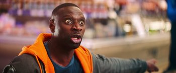 Movie still from “The Takedown” (2022), directed by Louis Leterrier – A person with an open mouth; Close Up shot, Over the shoulder angle