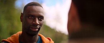 Movie still from “The Takedown” (2022), directed by Louis Leterrier – A man's face in front of another man; Close Up shot, Over the shoulder angle