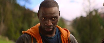 Movie still from “The Takedown” (2022), directed by Louis Leterrier – A person wearing a jacket; Close Up shot, Over the shoulder angle