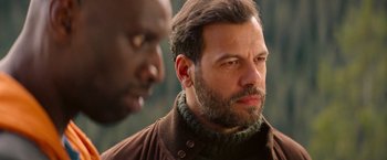 Movie still from “The Takedown” (2022), directed by Louis Leterrier – A man with a beard is looking at another man with a beard; Close Up shot, Over the shoulder angle