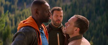 Movie still from “The Takedown” (2022), directed by Louis Leterrier – A group of men standing next to each other; Medium shot, Over the shoulder angle