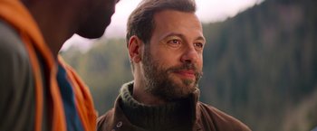 Movie still from “The Takedown” (2022), directed by Louis Leterrier – A person with a beard; Close Up shot, Over the shoulder angle