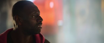 Movie still from “The Takedown” (2022), directed by Louis Leterrier – A person looking up at something; Close Up shot, Low angle