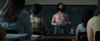 Movie still from “The Trial of the Chicago 7” (2020), directed by Aaron Sorkin – A man standing in front of a mirror in front of another man; Medium shot, Over the shoulder angle