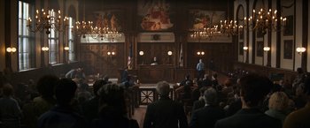 Movie still from “The Trial of the Chicago 7” (2020), directed by Aaron Sorkin – A court room filled with people in suits and hats; Extreme Wide shot, High angle