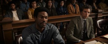 Movie still from “The Trial of the Chicago 7” (2020), directed by Aaron Sorkin – A group of people sitting in a court room; Medium shot, High angle