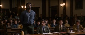 Movie still from “The Trial of the Chicago 7” (2020), directed by Aaron Sorkin – A group of people sitting in a court room; Medium shot, Low angle