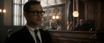 Movie still from “The Trial of the Chicago 7” (2020), directed by Aaron Sorkin – A man wearing a suit and glasses in a courtroom; Close Up shot, Over the shoulder angle