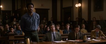 Movie still from “The Trial of the Chicago 7” (2020), directed by Aaron Sorkin – A group of people sitting in a court room; Medium shot, Over the shoulder angle