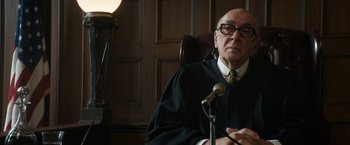 Movie still from “The Trial of the Chicago 7” (2020), directed by Aaron Sorkin – An old man in a judge's robe sitting at a podium; Close Up shot, Over the shoulder angle