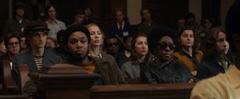 Movie still from “The Trial of the Chicago 7” (2020), directed by Aaron Sorkin – A group of people sitting in front of a crowd; Medium shot, Over the shoulder angle