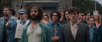 Movie still from “The Trial of the Chicago 7” (2020), directed by Aaron Sorkin – A group of men standing next to each other in a line; Medium shot, Over the shoulder angle