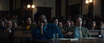 Movie still from “The Trial of the Chicago 7” (2020), directed by Aaron Sorkin – A group of people sitting in a room; Medium shot, Over the shoulder angle