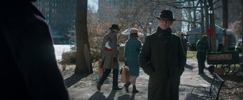 Movie still from “The Trial of the Chicago 7” (2020), directed by Aaron Sorkin – A man and two women walking down a sidewalk; Medium shot, Over the shoulder angle