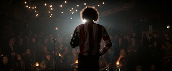 Movie still from “The Trial of the Chicago 7” (2020), directed by Aaron Sorkin – A man standing in front of a crowd of people; Wide shot, Over the shoulder angle