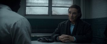 Movie still from “The Trial of the Chicago 7” (2020), directed by Aaron Sorkin – An older man sitting at a table in front of a window; Medium shot, Over the shoulder angle