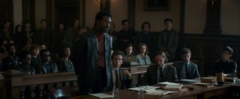 Movie still from “The Trial of the Chicago 7” (2020), directed by Aaron Sorkin – A group of people sitting in a room; Medium shot, Over the shoulder angle