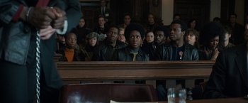 Movie still from “The Trial of the Chicago 7” (2020), directed by Aaron Sorkin – A group of people sitting in a court room; Medium shot, High angle