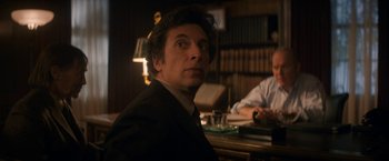 Movie still from “The Trial of the Chicago 7” (2020), directed by Aaron Sorkin – A man sitting at a table in front of another man; Close Up shot, Over the shoulder angle