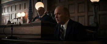 Movie still from “The Trial of the Chicago 7” (2020), directed by Aaron Sorkin – Two men sitting in front of a judge in a courtroom; Medium shot, Low angle