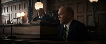 Movie still from “The Trial of the Chicago 7” (2020), directed by Aaron Sorkin – Two men in suits sitting in front of a judge's bench; Medium shot, Low angle