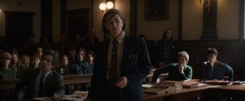 Movie still from “The Trial of the Chicago 7” (2020), directed by Aaron Sorkin – A man standing in front of a group of people in a courtroom; Medium shot, Over the shoulder angle