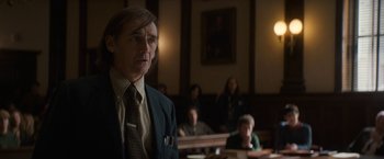 Movie still from “The Trial of the Chicago 7” (2020), directed by Aaron Sorkin – A man standing in front of a group of people in a court room; Medium shot, Over the shoulder angle