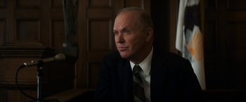 Movie still from “The Trial of the Chicago 7” (2020), directed by Aaron Sorkin – An older man in a suit and tie looking to his left; Close Up shot, Low angle