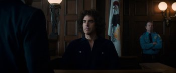 Movie still from “The Trial of the Chicago 7” (2020), directed by Aaron Sorkin – A man sitting in front of a judge in a courtroom; Medium shot, Low angle