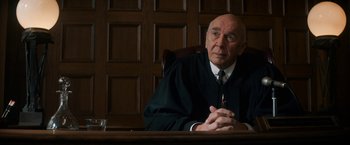 Movie still from “The Trial of the Chicago 7” (2020), directed by Aaron Sorkin – An older man sitting in a judge's chair in a courtroom; Close Up shot, Low angle
