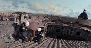 Movie still from “The Two Popes” (2019), directed by Fernando Meirelles – Two firemen are on the roof of a building; Extreme Wide shot, High angle