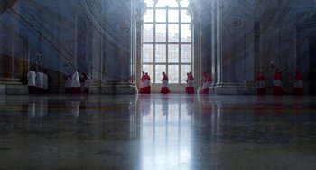 Movie still from “The Two Popes” (2019), directed by Fernando Meirelles – A group of people sitting in front of a large window; Extreme Wide shot, Low angle