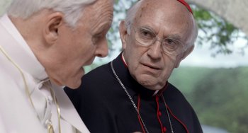 Movie still from “The Two Popes” (2019), directed by Fernando Meirelles – Two older men talking to each other; Close Up shot, Over the shoulder angle