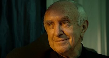 Movie still from “The Two Popes” (2019), directed by Fernando Meirelles – An older man with a white beard looking into the distance; Close Up shot, Low angle