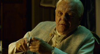 Movie still from “The Two Popes” (2019), directed by Fernando Meirelles – An old man holding a napkin in his hand; Close Up shot, Over the shoulder angle