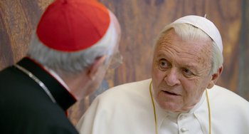 Movie still from “The Two Popes” (2019), directed by Fernando Meirelles – A man in a priest's outfit talking to an older man; Close Up shot, Over the shoulder angle