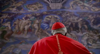 Movie still from “The Two Popes” (2019), directed by Fernando Meirelles – A man in a red robe and a red hat is in front of a painting; Close Up shot, Over the shoulder angle