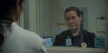Movie still from “The Unforgivable” (2021), directed by Nora Fingscheidt – A woman in a police uniform sitting in front of a bathroom mirror; Close Up shot, Over the shoulder angle