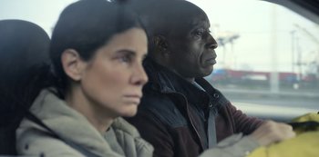 Movie still from “The Unforgivable” (2021), directed by Nora Fingscheidt – A man and a woman sitting next to each other; Close Up shot, Over the shoulder angle