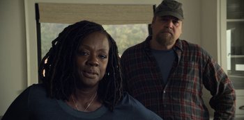 Movie still from “The Unforgivable” (2021), directed by Nora Fingscheidt – A man and a woman standing next to each other; Medium shot, Over the shoulder angle