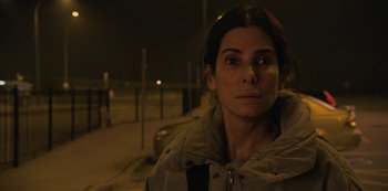 Movie still from “The Unforgivable” (2021), directed by Nora Fingscheidt – A woman is standing in the street at night; Close Up shot, High angle