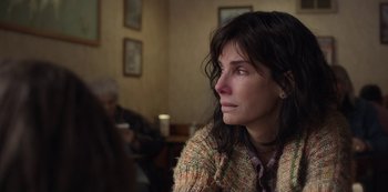 Movie still from “The Unforgivable” (2021), directed by Nora Fingscheidt – A woman sitting in front of a wall looking up; Close Up shot, Over the shoulder angle