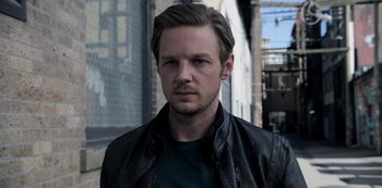 Movie still from “The Unforgivable” (2021), directed by Nora Fingscheidt – A person wearing a leather jacket; Close Up shot, Low angle