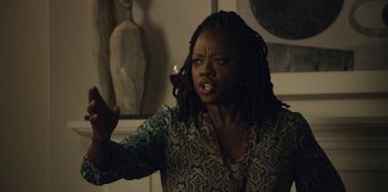 Movie still from “The Unforgivable” (2021), directed by Nora Fingscheidt – A woman with dreadlocks in a room; Medium shot, Over the shoulder angle