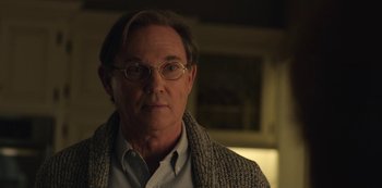 Movie still from “The Unforgivable” (2021), directed by Nora Fingscheidt – A person wearing glasses and a sweater; Close Up shot, Over the shoulder angle